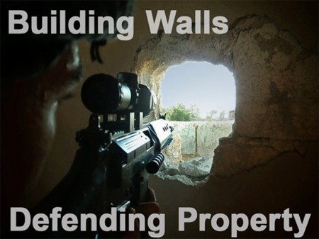 Member of the Free Syrian Army points his weapon through a hole in a wall as he takes up a defense position in a house in Qusseer neighbourhood in Homs